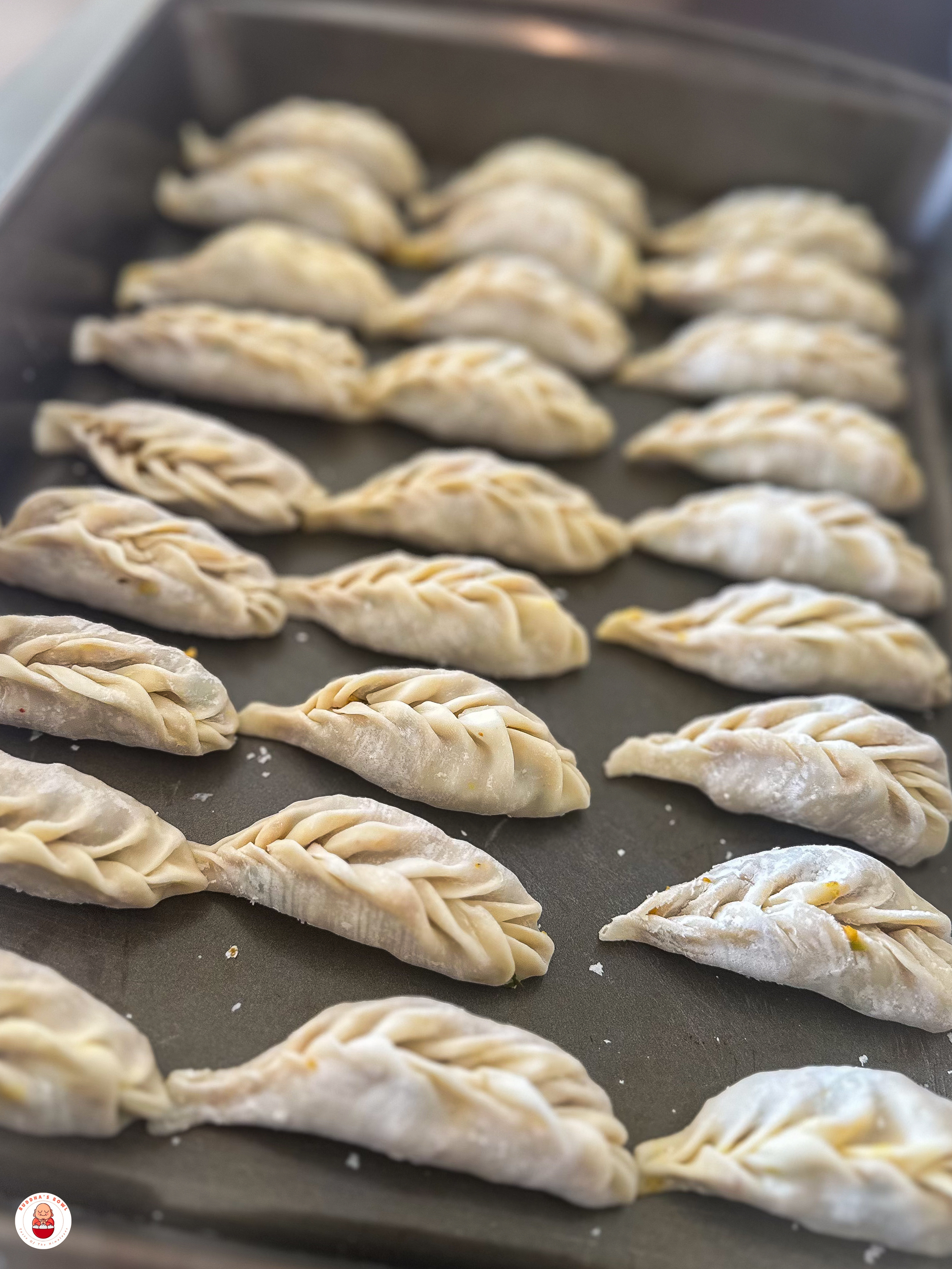Frozen paneer momos on tray