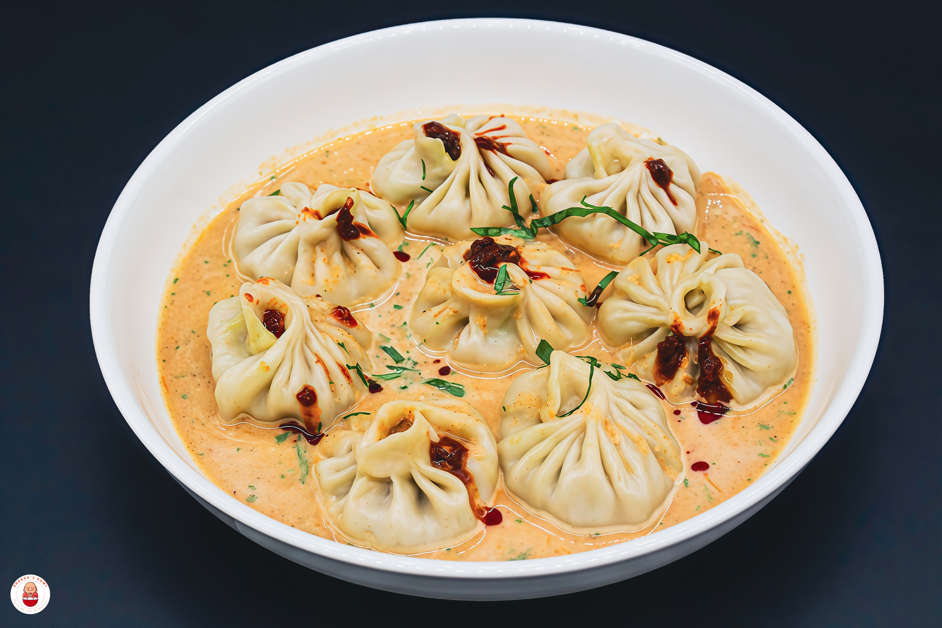 Jhol momos in warm tomato-sesame broth