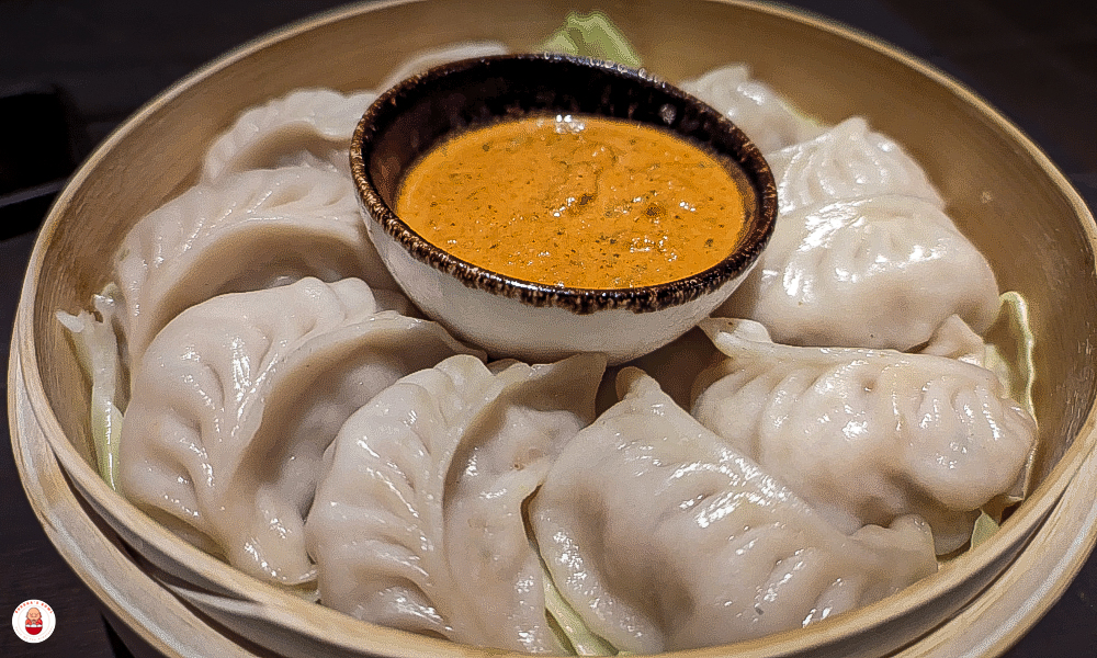 Steamed momos with tomato-sesame dip